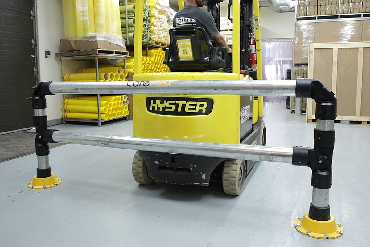 Three-step infographic showing a removable bollard workflow: closed position with post installed and locked in the ground sleeve, removed position with a worker lifting the post out of the sleeve, and safe/covered position with the hinged cover flipped down flat over the sleeve opening.