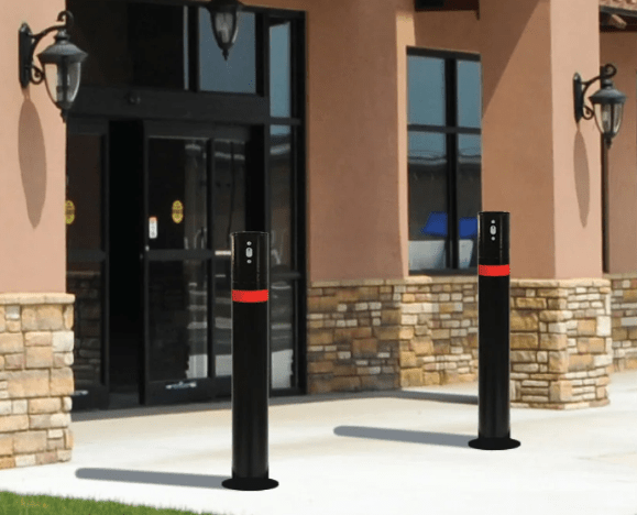 Three-step infographic showing a removable bollard workflow: closed position with post installed and locked in the ground sleeve, removed position with a worker lifting the post out of the sleeve, and safe/covered position with the hinged cover flipped down flat over the sleeve opening.