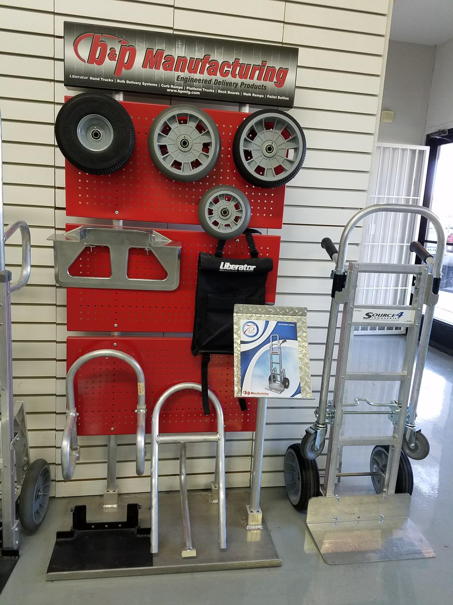 Red hand truck and industrial storage gear for warehouse logistics.